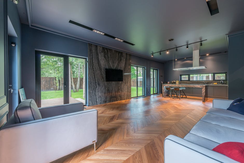 Contemporary living room featuring wooden floors, large windows, and stylish decor.