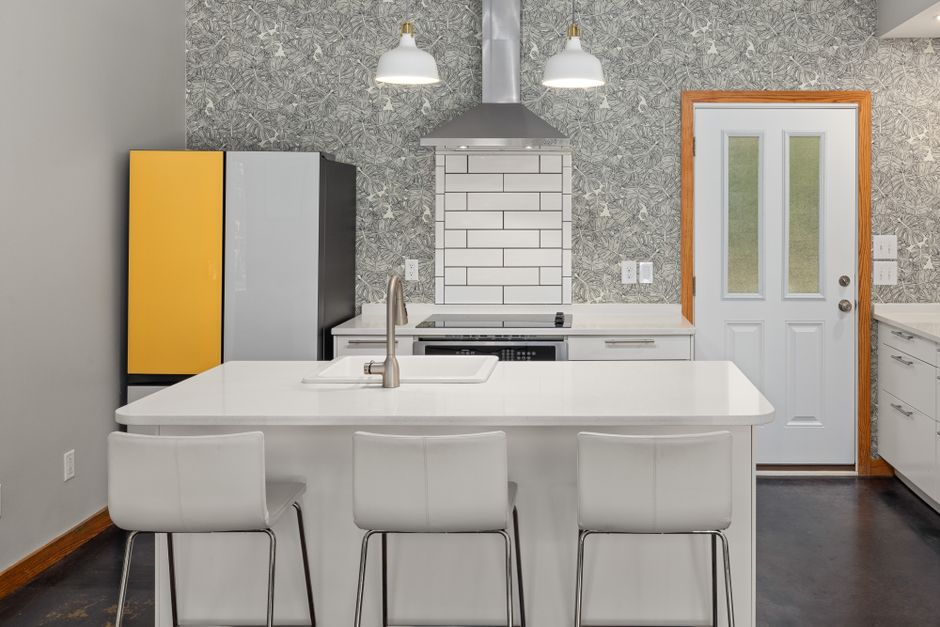 Contemporary kitchen featuring an island, pendant lights, and modern appliances.